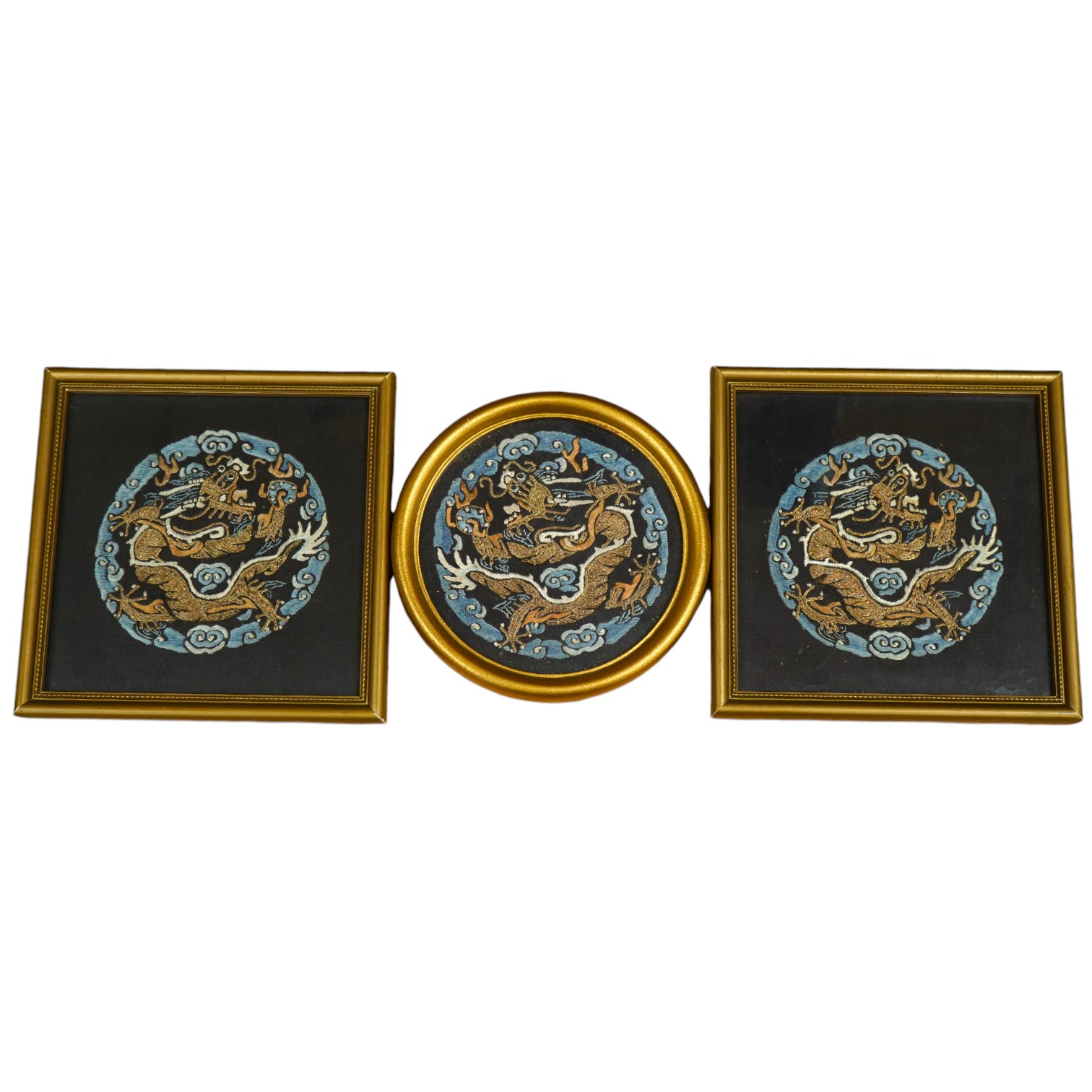 Three Chinese early 20th century embroidered roundels of five claw dragons, embroidered in gold thread and blue silk thread possibly symbolic motifs cut from a robe, embroidery 9cm diameter. Condition - embroidery good,